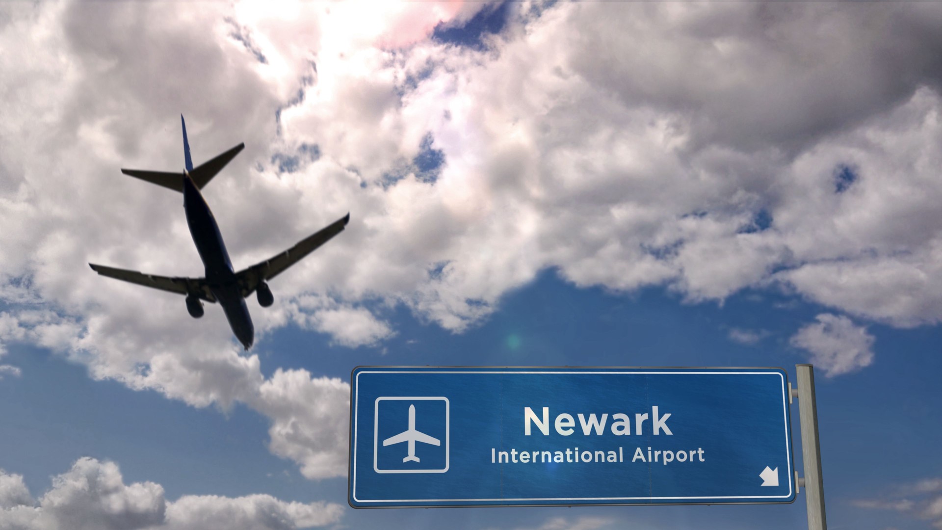 Plane landing in Newark New Jersey, USA airport with signboard